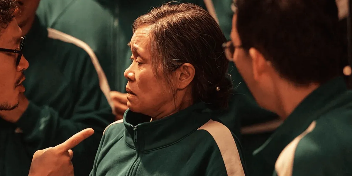 Geum-ja looking at her son who is pointing in Squid Game season 2