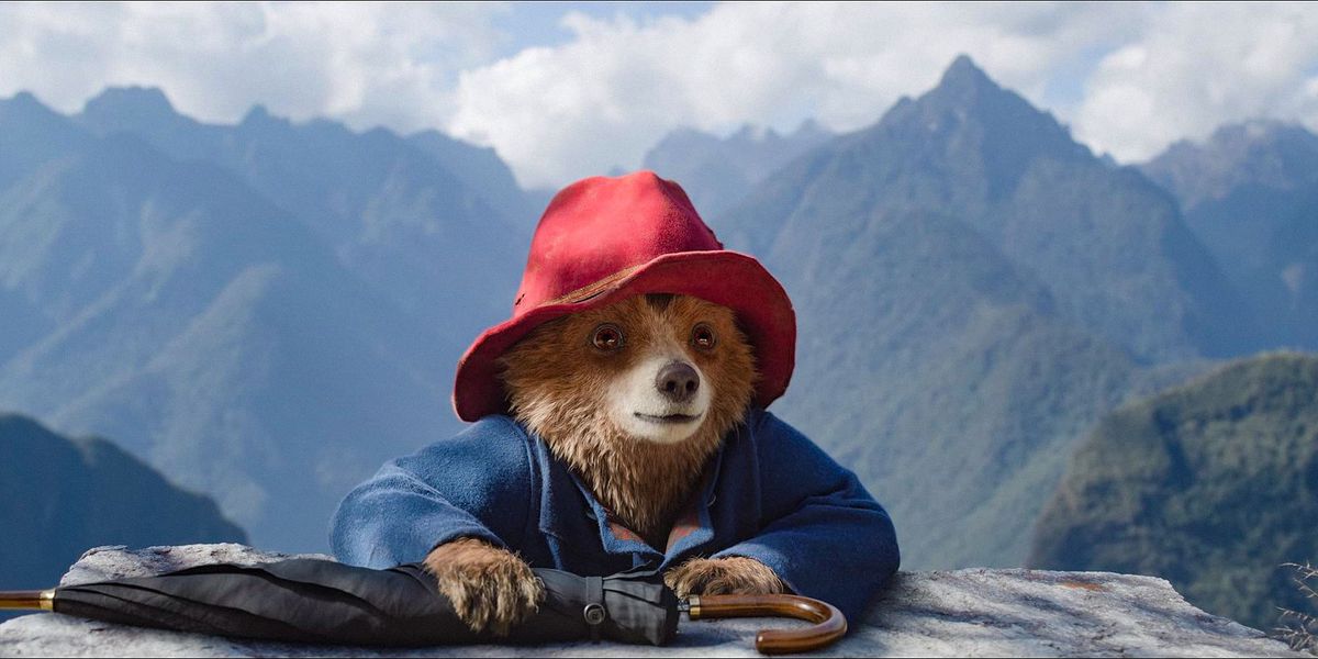 Paddington reaching the top of a mountain in Paddington in Peru