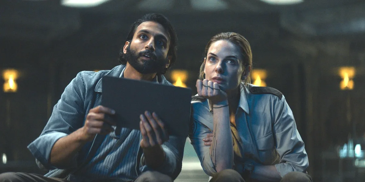 Juliette Nichols (Rebecca Ferguson) and Lukas Kyle (Avi Nash) looking at the outside display in Silo season 1