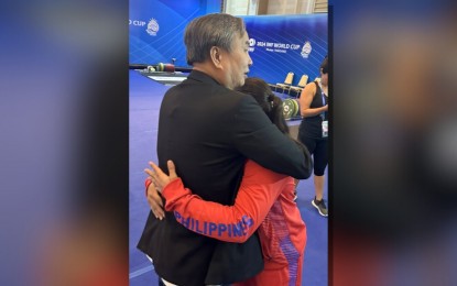 <p><strong>ALWAYS GOLDEN. </strong>Philippine Olympic Committee president Abraham Tolentino consoles Hidilyn Diaz after her stint in the International Weightlifting Federation World Cup in Phuket, Thailand on Wednesday (April 3, 2024). Diaz placed 11th in the women's 59 kg category of the final qualifying event for the Paris Olympics, missing out on a fifth consecutive Summer Games stint. <em>(Contributed photo) </em></p>