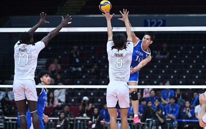 <p><strong>TOUGH TRY.</strong> Ateneo's Jian Salarzon attempts to score against University of the Philippines' Olayemi Raheem (left) and Daniel Nicolas (No. 8) during their UAAP Season 87 men’s volleyball match at Mall of Asia Arena in Pasay City on Saturday (March 22, 2025). The Blue Eagles won, 25-16, 25-18, 25-21, for a third-best 5-3 card. <em>(UAAP photo)</em></p>