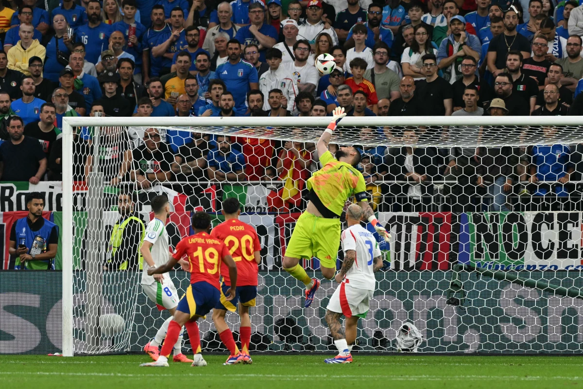 Italy's goalkeeper #01 Gianluigi Donnarumma (2R) deflects a shot during the UEFA Euro 2024 Group B football match between Spain and Italy at the Arena AufSchalke in Gelsenkirchen on June 20, 2024. (Photo by OZAN KOSE / AFP) (Photo by OZAN KOSE/AFP via Getty Images)