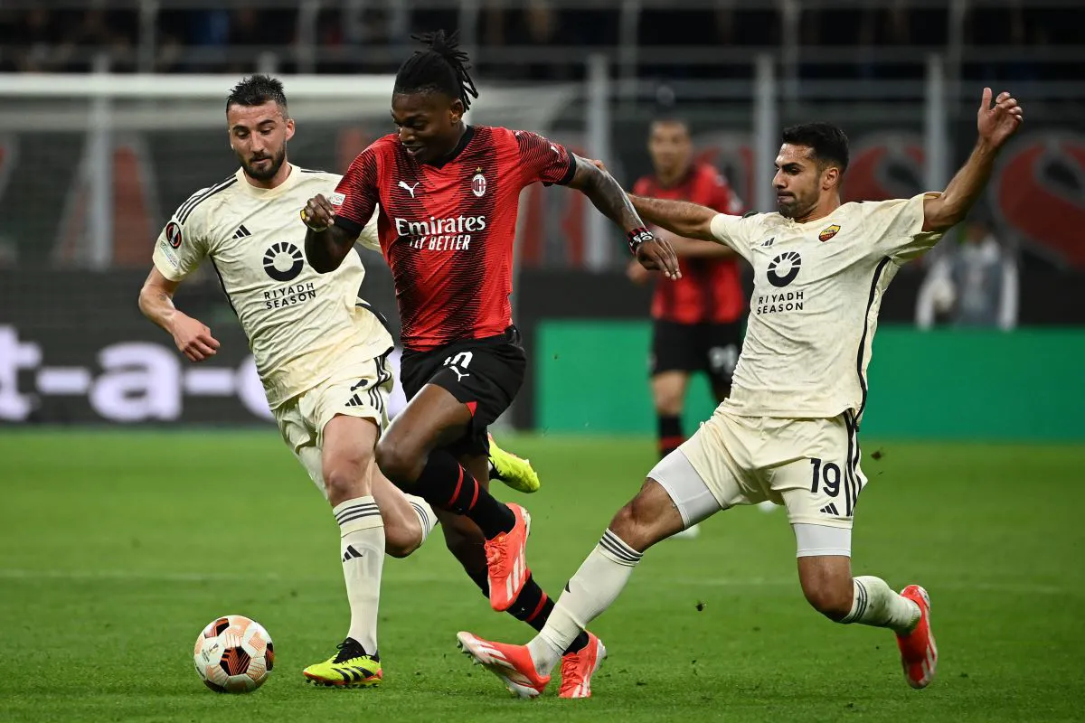 Rafael Leao takes on Zeki Celik and Bryan Cristante of Roma during the Europa League quarter-final first leg at the Stadio Giuseppe Meazza in San Siro (April 2024) (Coppa Italia quarter-final 2024/25)