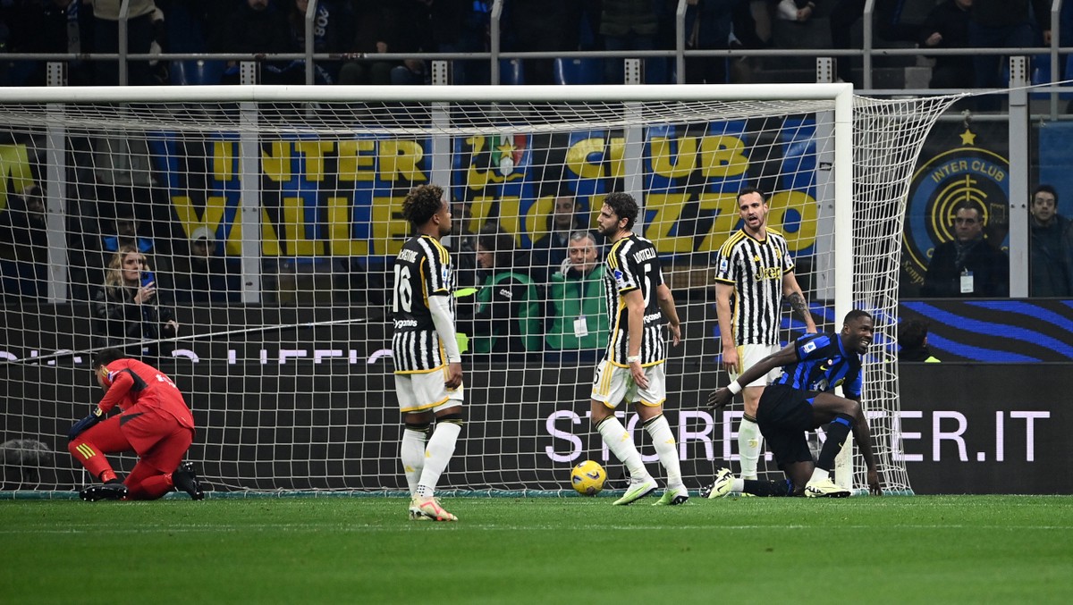 Inter Milan's French forward #09 Marcus Thuram (R) celebrates his team's first goal, following an own-goal attributed to Juventus' Italian defender #04 Federico Gatti (2nd R) during the Serie A football match between Inter Milan and Juventus at the San Siro stadium in Milan, on February 4, 2024. (Photo by Isabella BONOTTO / AFP) (Photo by ISABELLA BONOTTO/AFP via Getty Images)