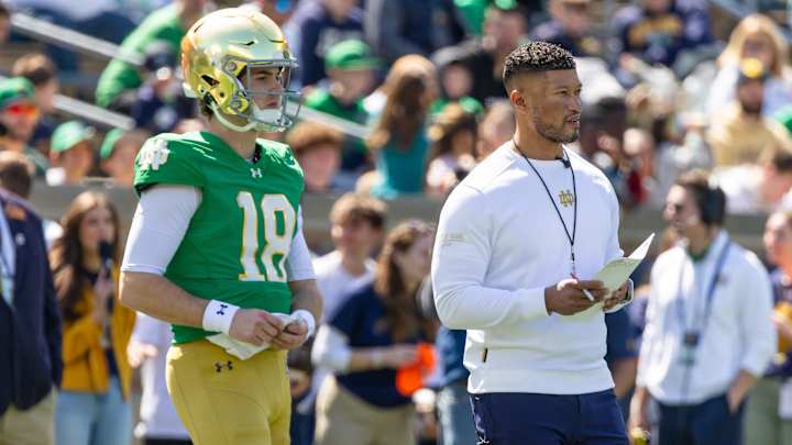 Apr 12, 2025; Notre Dame, IN, USA; Notre Dame Fighting Irish quarterback Steve Angeli (18) watches alongside head coach Marcus Freeman during the Blue-Gold game at Notre Dame Stadium. Mandatory Credit: Michael Caterina-Imagn Images Apr 12, 2025; Notre Dame, IN, USA; Notre Dame Fighting Irish quarterback Steve Angeli (18) watches alongside head coach Marcus Freeman during the Blue-Gold game at Notre Dame Stadium. Mandatory Credit: Michael Caterina-Imagn Images