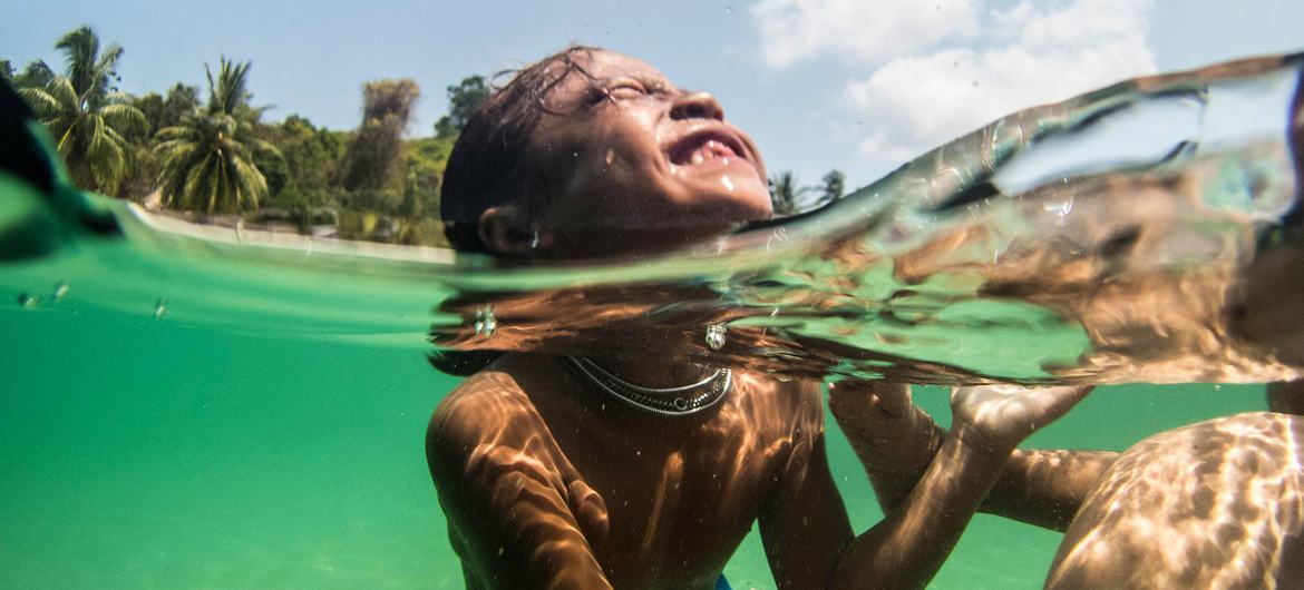 Moken children swim in the Myeik Archipelago in Myanmar. Moken children swim in the Myeik Archipelago in Myanmar.