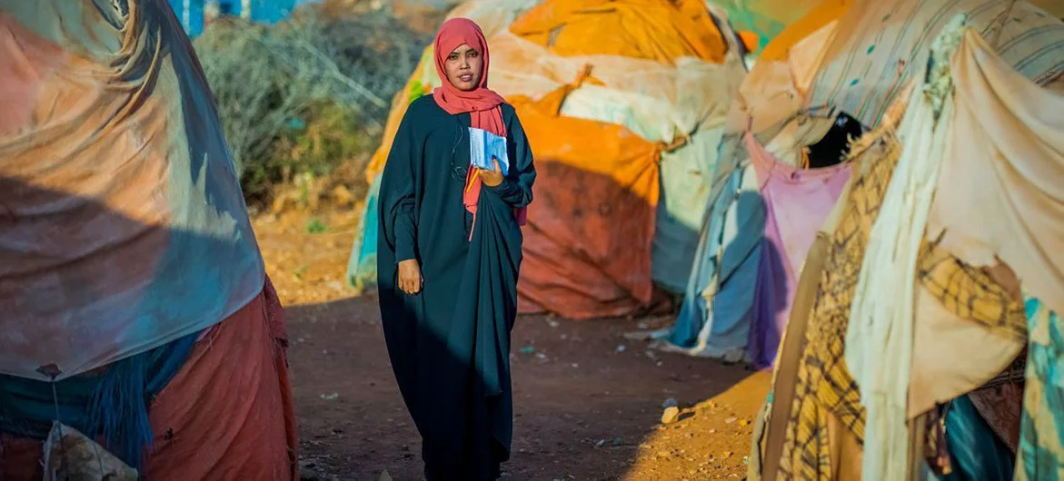 A case worker at a camp for internally displaced people in Somalia helps abused women get medical care. A case worker at a camp for internally displaced people in Somalia helps abused women get medical care.