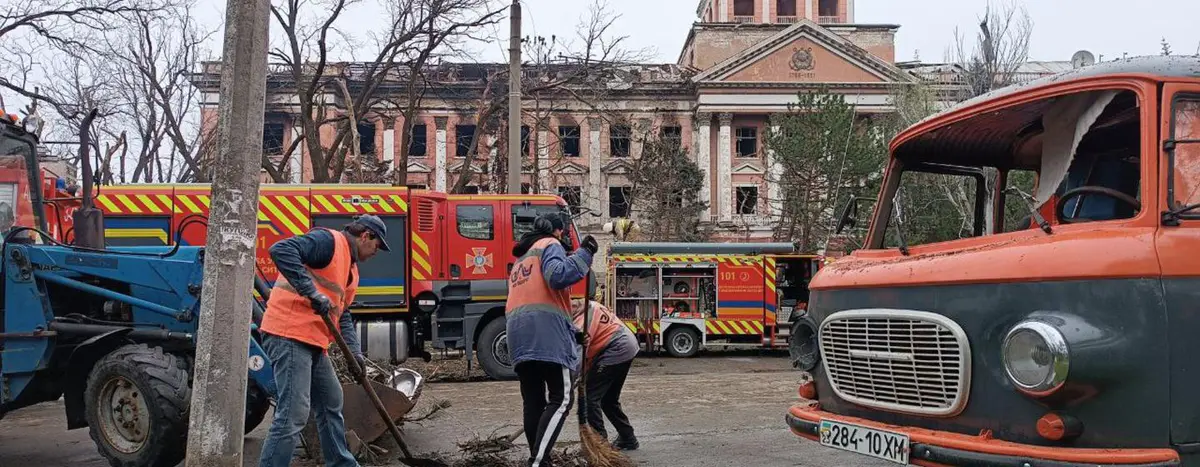 Municipal workers clear up the remnants of shelling in Mykolaiv. 
