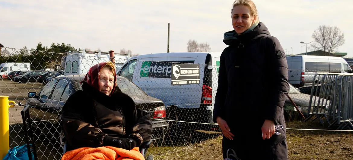 Ukrainian women, fleeing escalating conflict, wait for a lift to reach a refugee centre in Poland. Ukrainian women, fleeing escalating conflict, wait for a lift to reach a refugee centre in Poland.