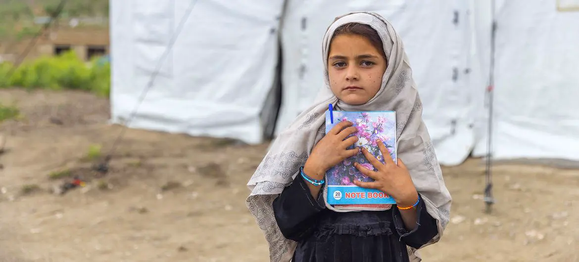 A young girl stands outside a child-friendly space established to help children cope with their trauma after the June 2022 earthquake in Afghanistan. A young girl stands outside a child-friendly space established to help children cope with their trauma after the June 2022 earthquake in Afghanistan.