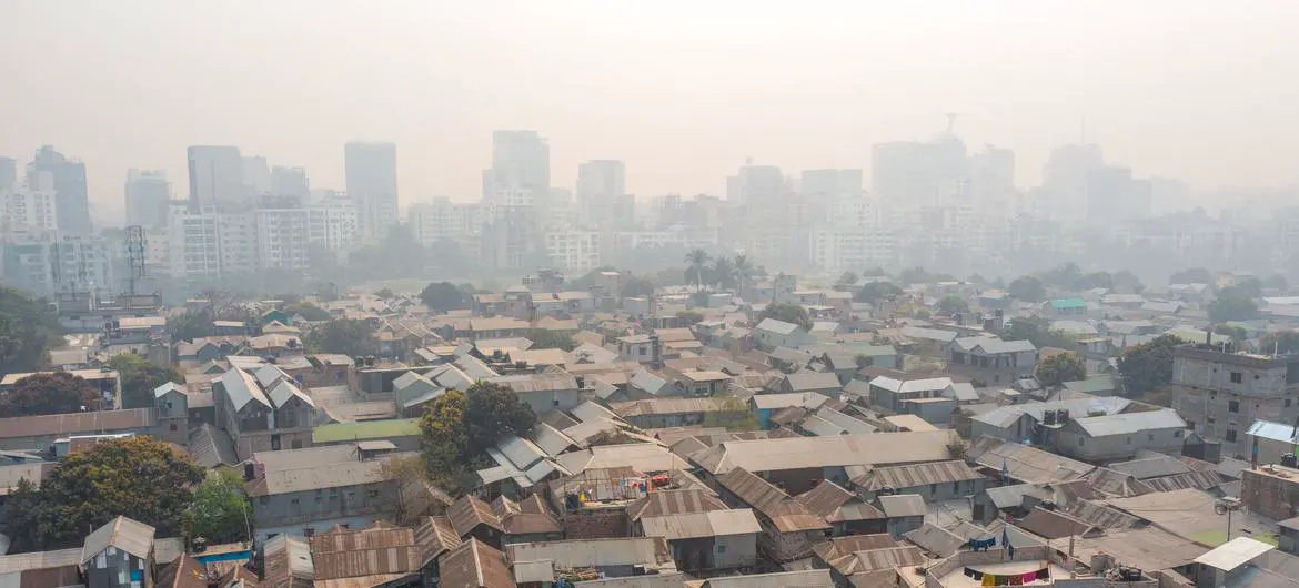In Dhaka, stark inequality is laid bare as informal settlements sprawl in the foreground, shadowed by rising high-rises in the distance.