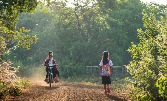 Kres village, Cambodia. 11-year old Loul Bopha makes the short walk from her home to the school Kres village, Cambodia. 11-year old Loul Bopha makes the short walk from her home to the school