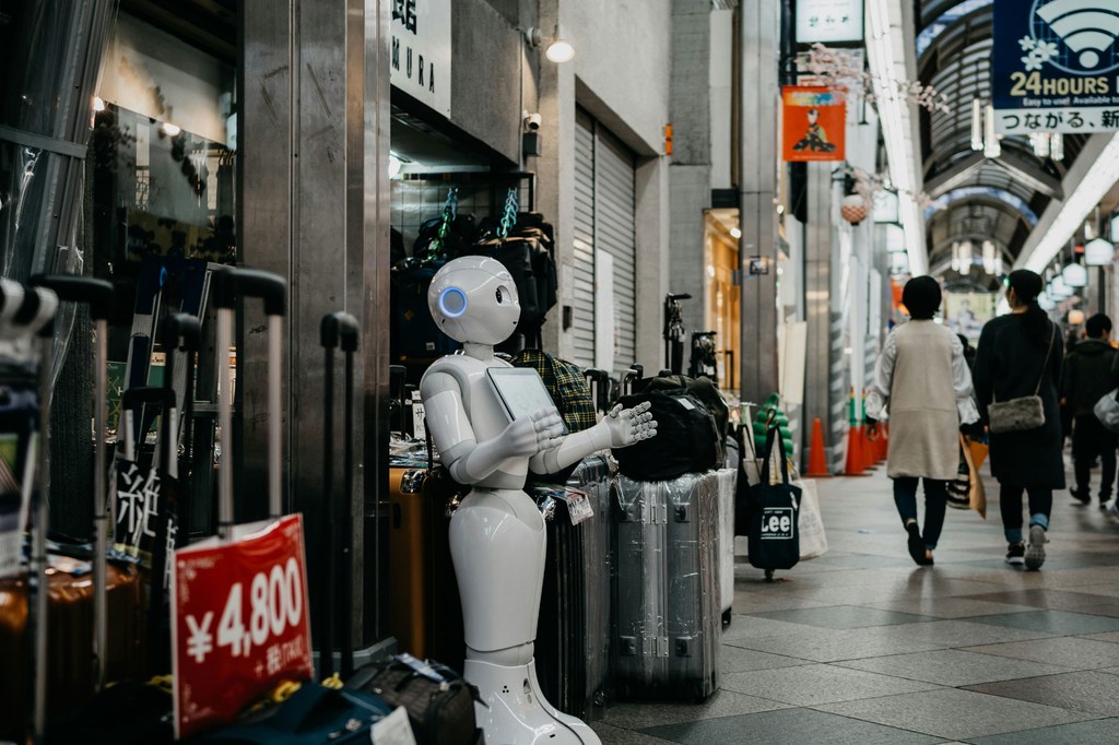 A robot which could carry out tasks assigned to humans stands in a shopping mall in Kyoto, Japan. A robot which could carry out tasks assigned to humans stands in a shopping mall in Kyoto, Japan.