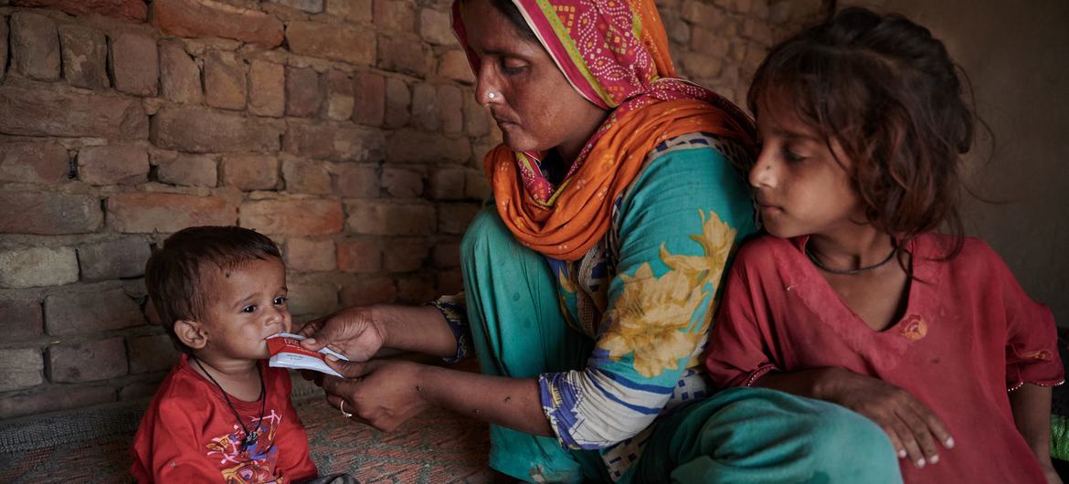 A young child suffering from malnutrition is fed by his mother at home in a village that was devastated by the floods in Pakistan. A young child suffering from malnutrition is fed by his mother at home in a village that was devastated by the floods in Pakistan.