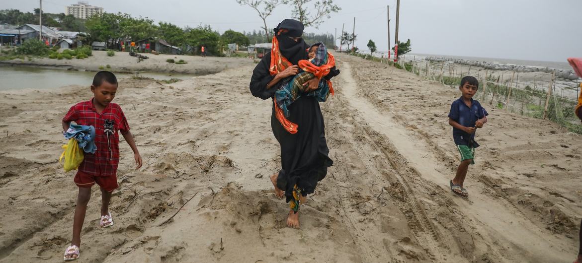 A mother along with her children, from the village of Panjupara, making their way a cyclone shelter, ahead of Cyclone Remal's landfall in Bangladesh on 26 May 2024. A mother along with her children, from the village of Panjupara, making their way a cyclone shelter, ahead of Cyclone Remal's landfall in Bangladesh on 26 May 2024.