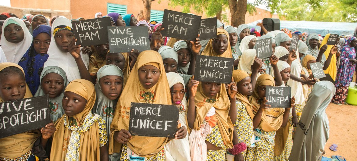 Young girls in the village of Danja in Niger hold signs in support of the Spotlight Initiative. Young girls in the village of Danja in Niger hold signs in support of the Spotlight Initiative.