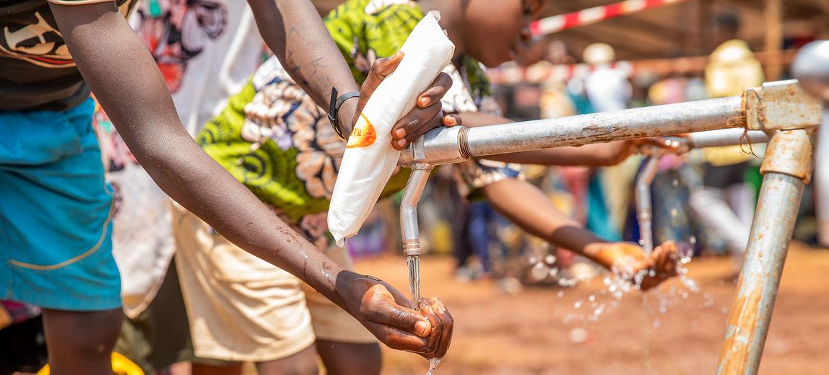 People who fled violence in DR Congo to Burundi use a water point at a refugee camp in Cibitoke Province. People who fled violence in DR Congo to Burundi use a water point at a refugee camp in Cibitoke Province.