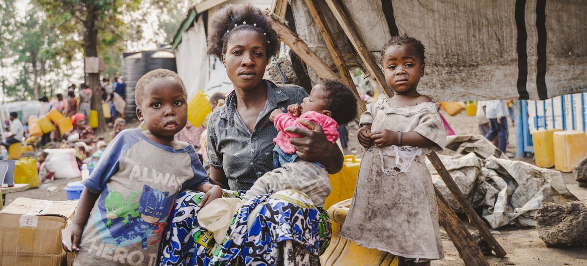 A displaced family sit in front of their makeshift shelter in Goma, North Kivu province, DR Congo. A displaced family sit in front of their makeshift shelter in Goma, North Kivu province, DR Congo.