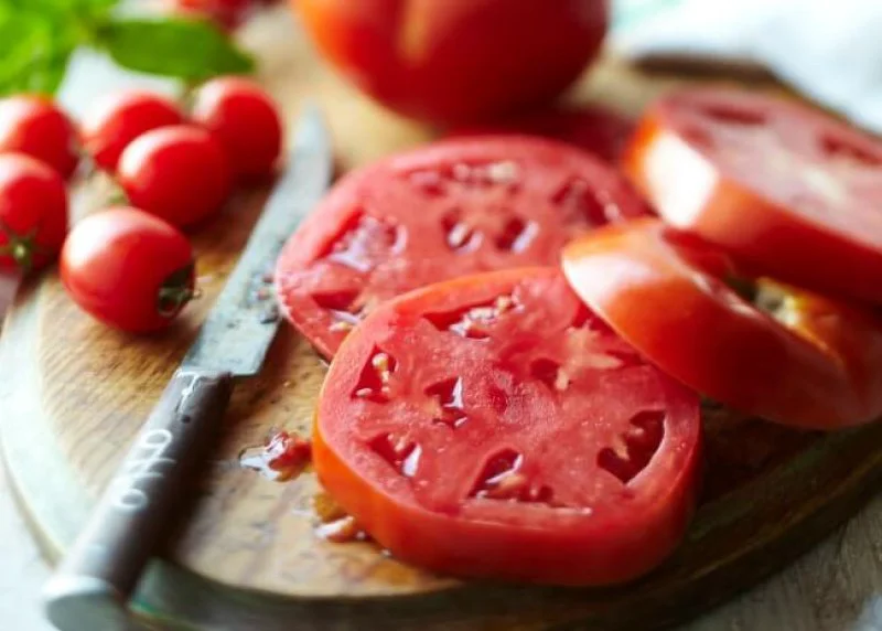 Sliced tomato on cutting board Photo by Meredith