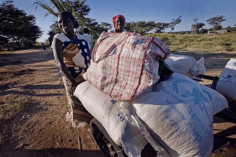 A woman carries a village's food aid in Harare, Zimbabwe. Supplies like these were rejected by the Zambian government after being misled about the food. Credit: Kate Holt and AusAID via CC-BY-2.0