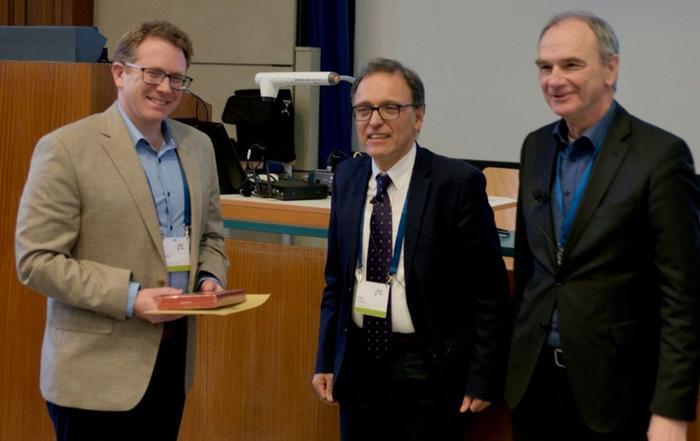 Ben Jones, left, accepting his award in Vienna
