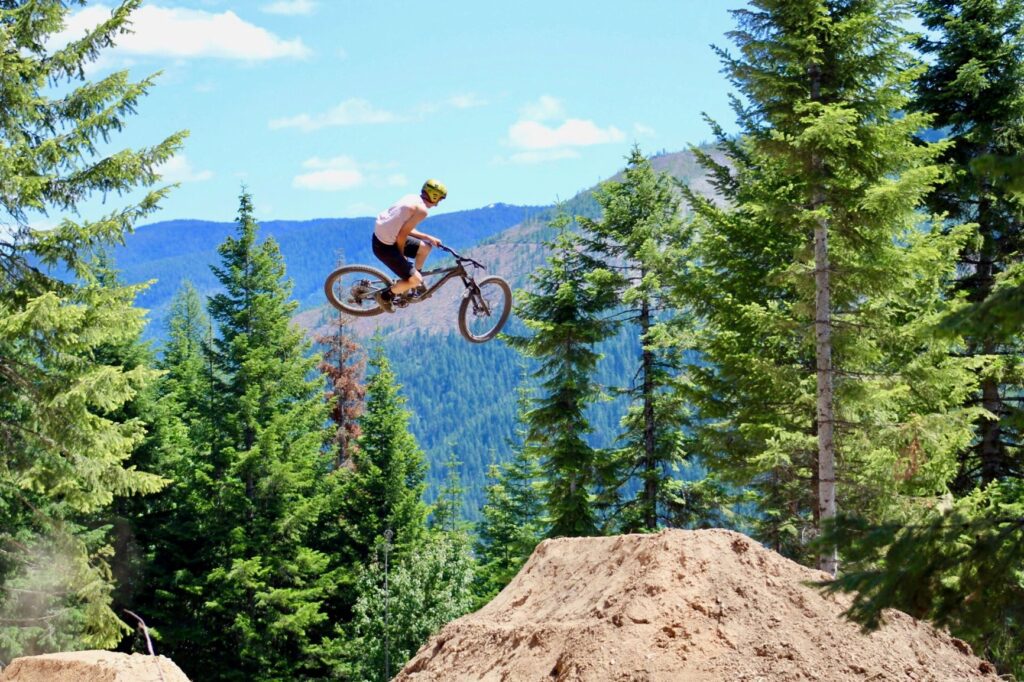 Mountain biker getting big air off a jump at SVR Bike Park in Wallace, Idaho.
