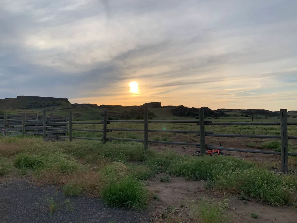 Fields and old fence at Escura Ranch at sunset.