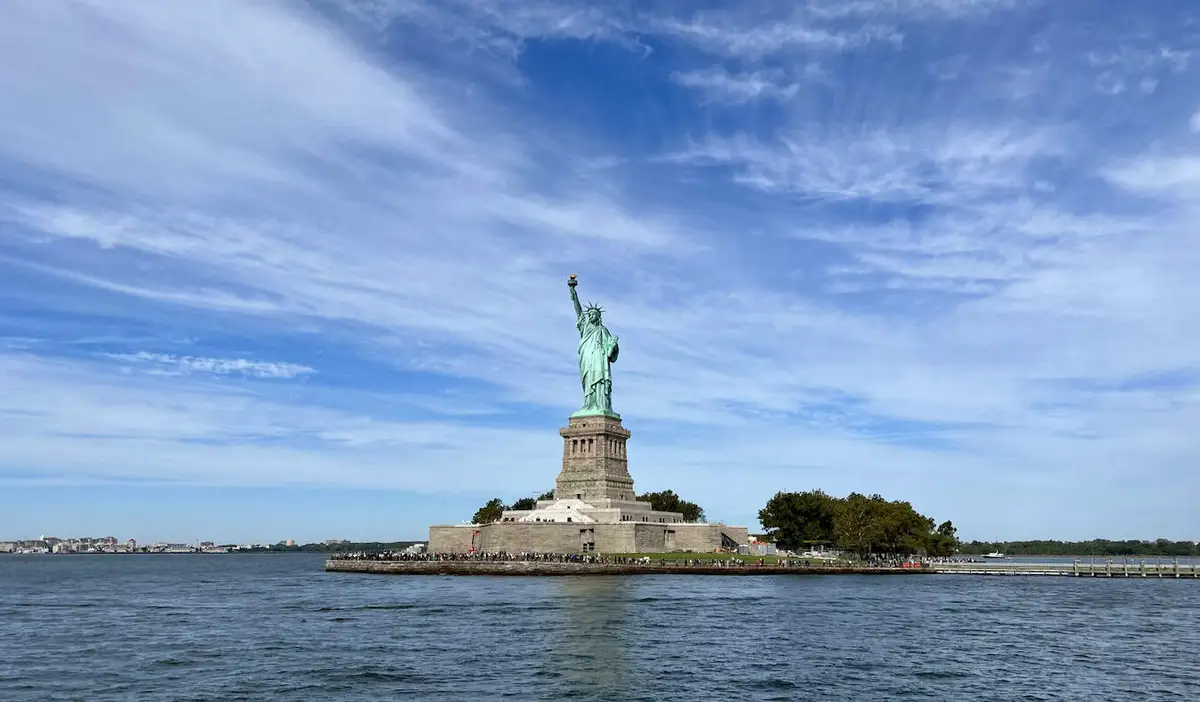 The towering and iconic Statue of Liberty in NYC on a sunny summer day