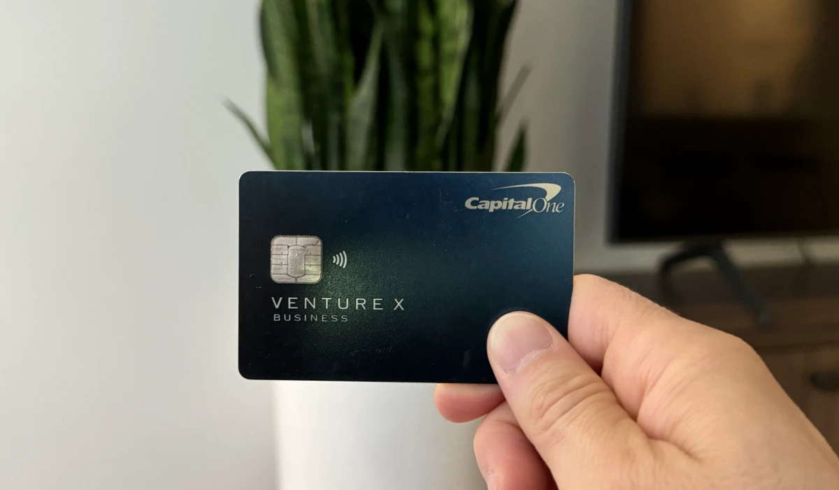 Nomadic Matt holding up his Capital One Venture X business card