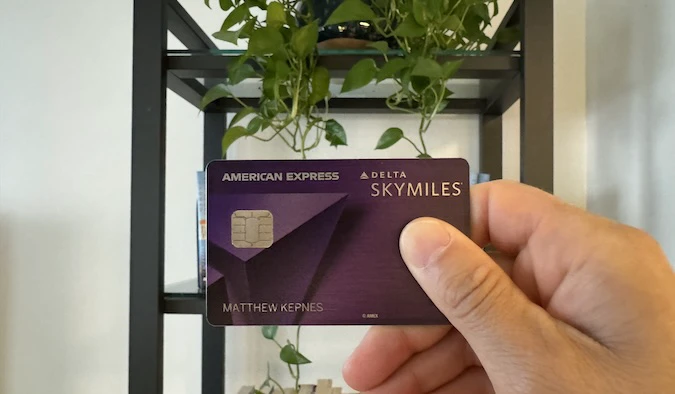 Picture of Nomadic Matt holding his Delta Reserve Credit Card