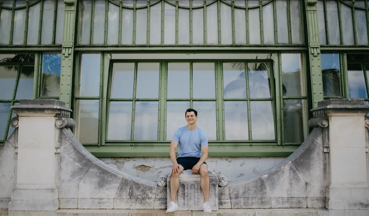 Nomadic Matt sitting on a bridge in Vienna, Austria
