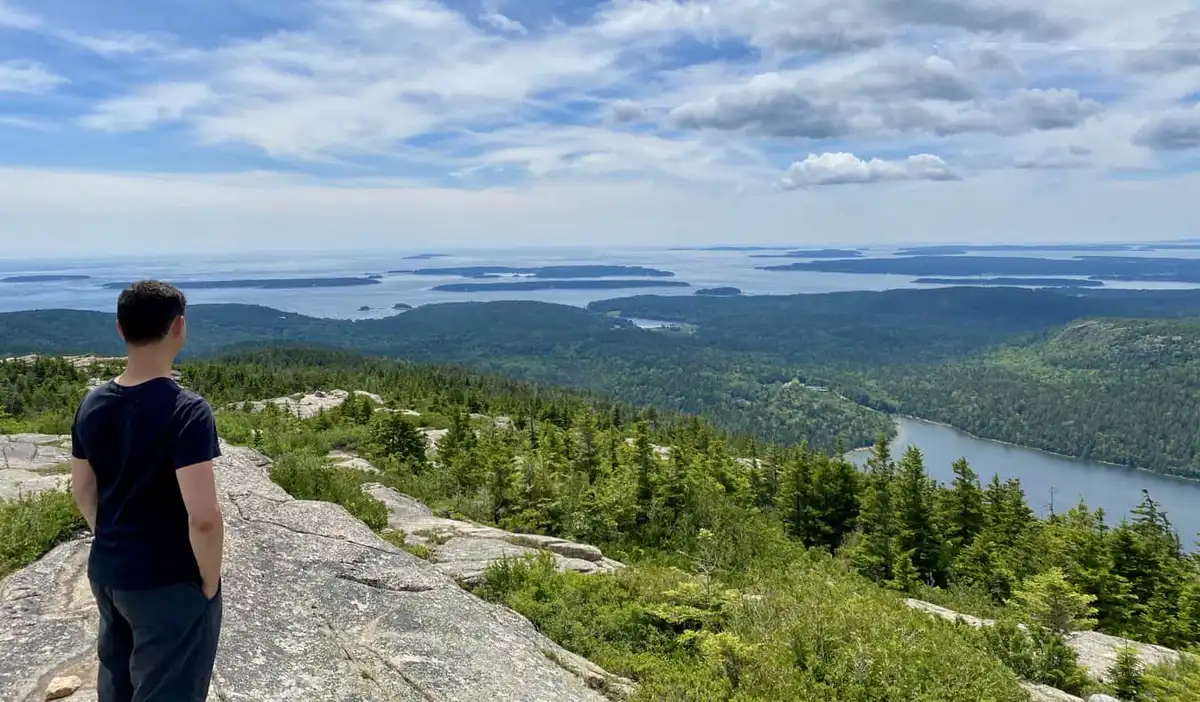 Nomadic Matt posing for a photo while hiking in New England, USA