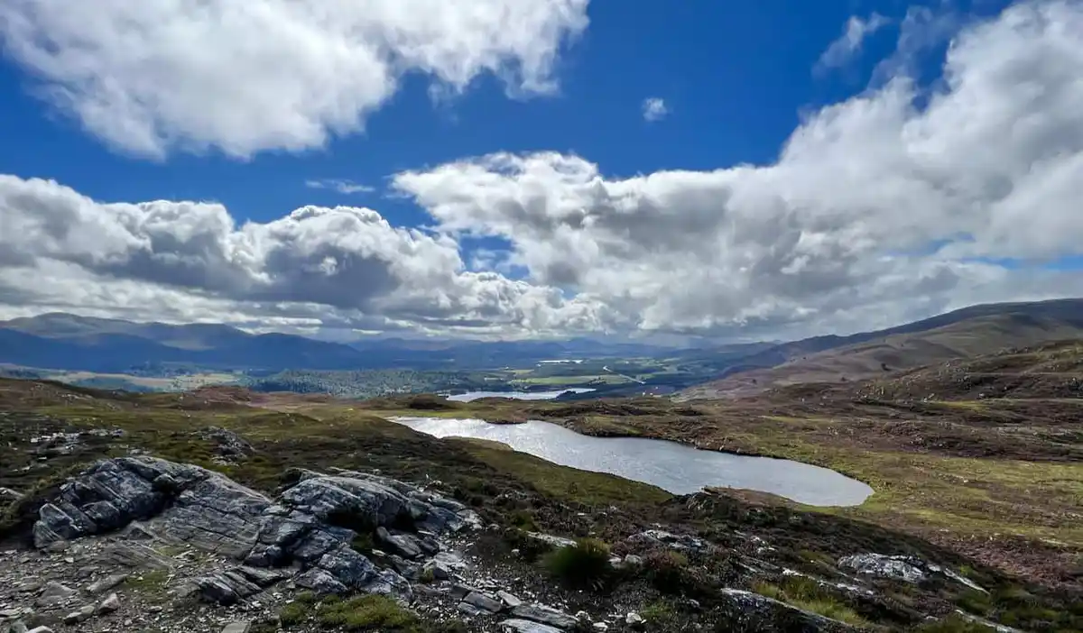A beautiful blue sky over the rugged highlands of Scotland on a road trip