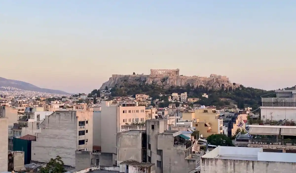 A pastel sunset overlooking the Acropolis in historic Athens, Greece