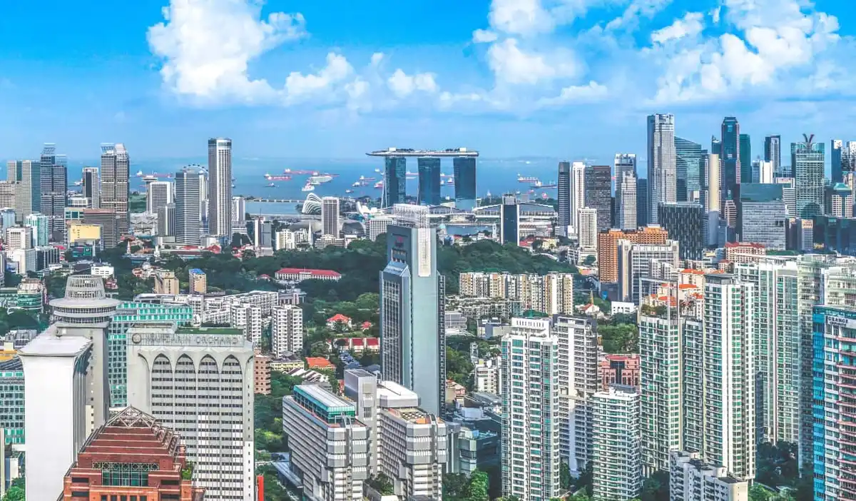 The Singapore city skyline, densely packed with skyscrapers on a sunny day