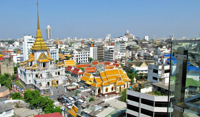 A dated picture of Bangkok's skyline, with a temple in the foreground