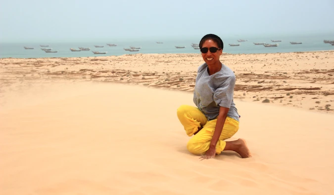 An expat teacher in Saudi Arabia posing on sand dune
