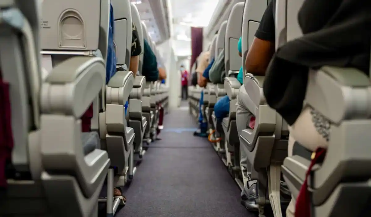 An empty aisle in the economy section of a commercial airplane