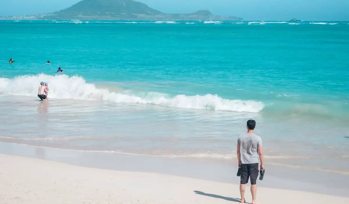 Nomadic Matt standing on a beach in Hawaii