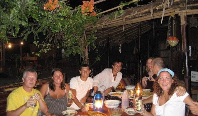 Nomadic Matt hanging out with other travelers at night