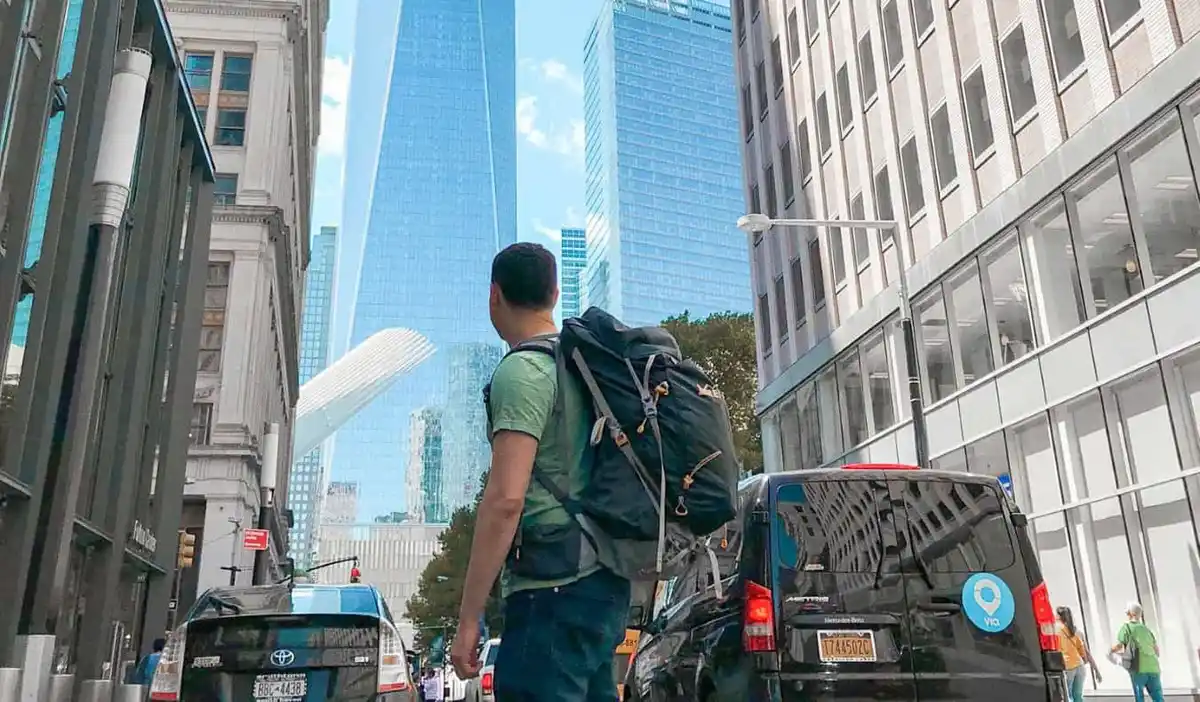 Nomadic Matt standing with his backpack in a busy NYC street