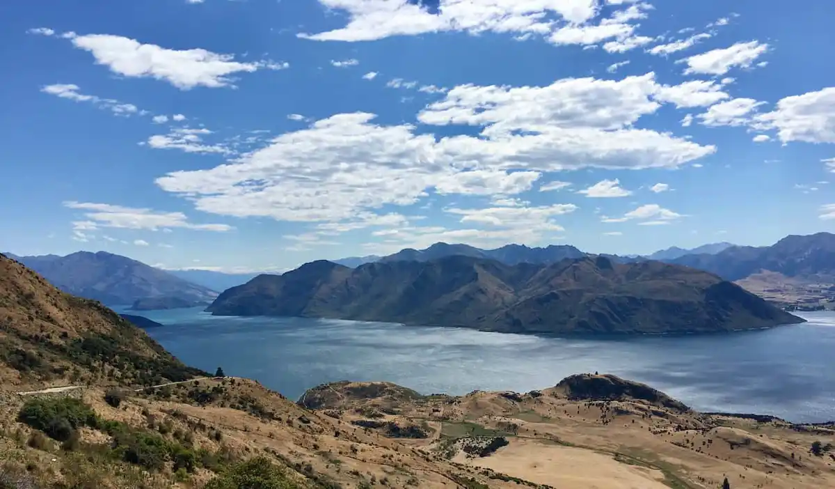 A beautiful, sunny day with blue skies in stunning New Zealand, with mountains and water filling the distance