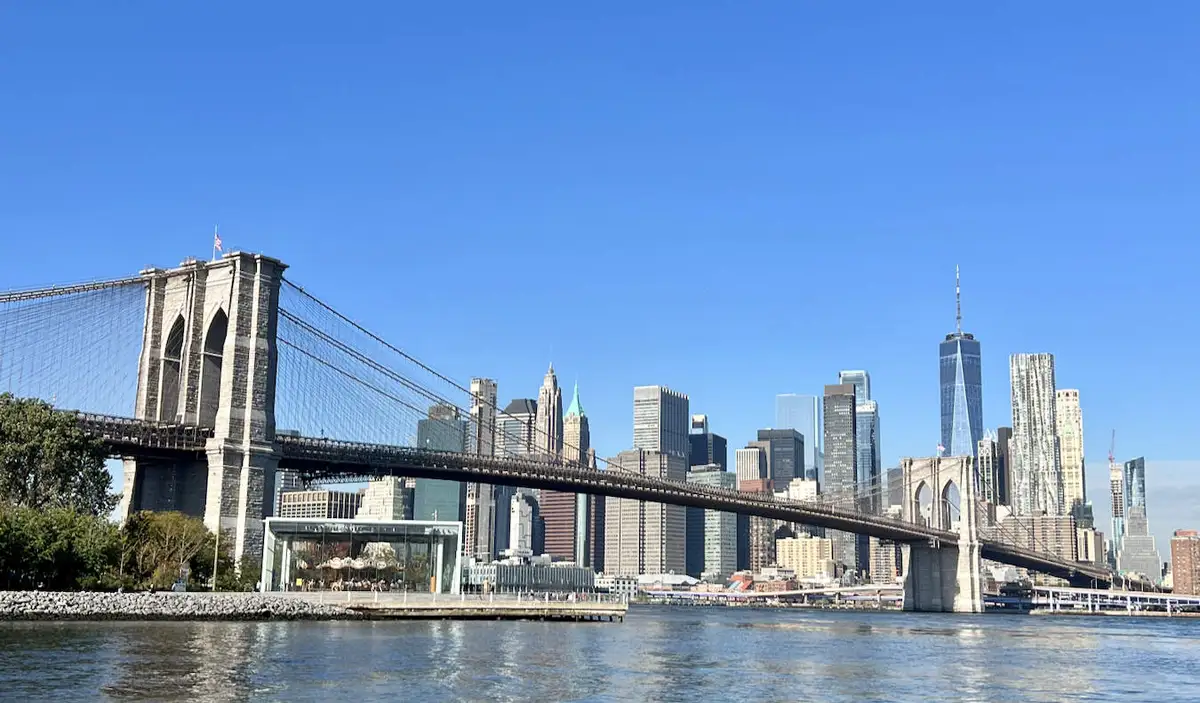 A blue sky and sunny day overlooking the towering skyline of Manhattan, NYC