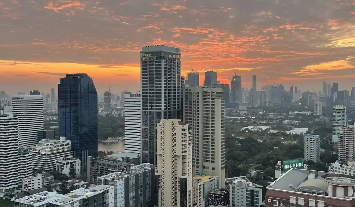 The skyline of Bangkok at sunset with towering skyscrapers all around